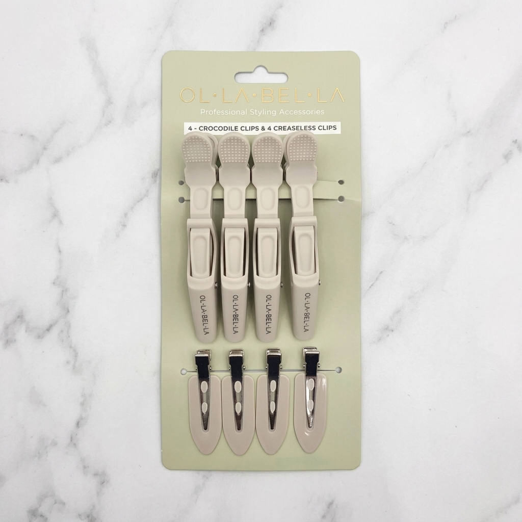 The Olla Bella Mane Master Hair Clip Set which includes four Olla Bella Crocodile Clips and four Olla Bella Creaseless Clips, arranged in two rows of two on a marble background.