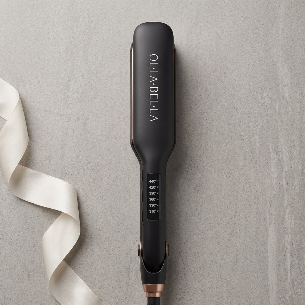 An Olla Bella 2" Wide Plate Hair Straightener on a textured gray background with a white ribbon on the left side.
